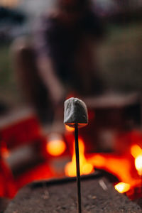 Close-up of lit candles on wood