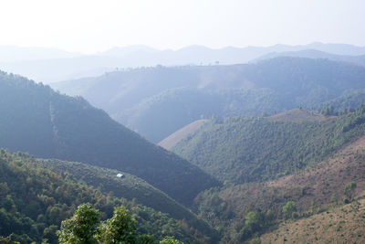 High angle view of valley and mountains against sky