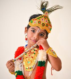 Portrait of boy wearing costume against white background