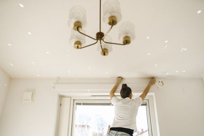 Woman preparing room for painting