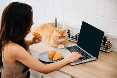 Woman using laptop on table