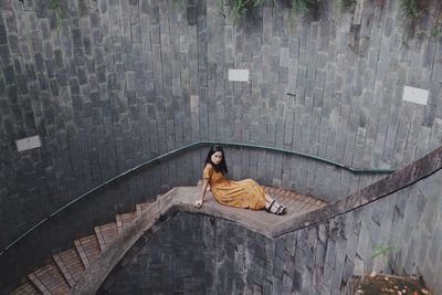 High angle portrait of woman sitting outdoors