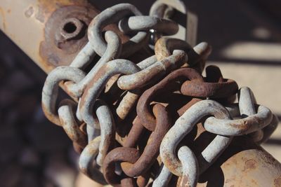 Close-up of rusty chain on pole