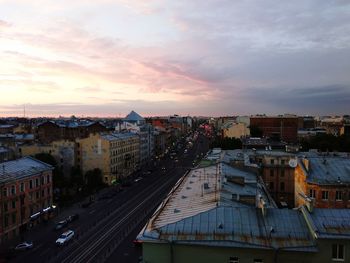 High angle view of road by buildings against sky during sunset