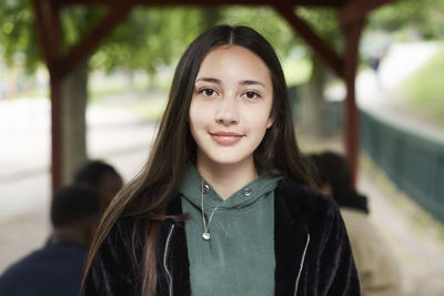 Portrait confident female teenage girl at park