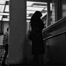 Woman looking through window
