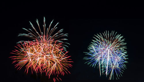 Low angle view of firework display at night