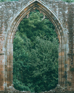 Low angle view of building seen through window