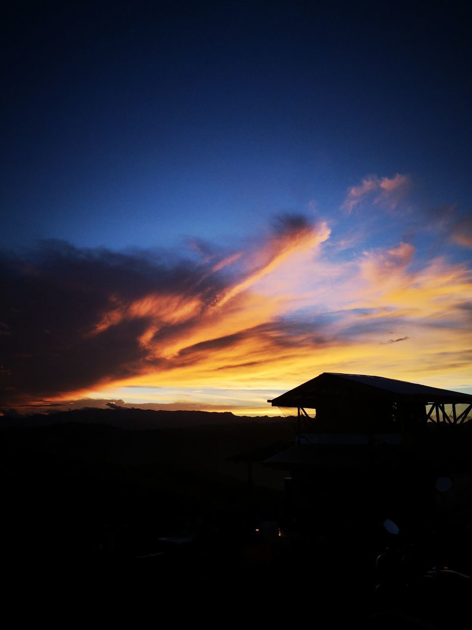 SILHOUETTE BUILDING AGAINST SKY AT SUNSET