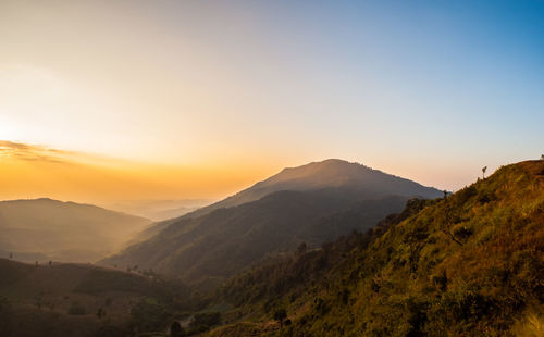 Scenic view of mountains against sky during sunset