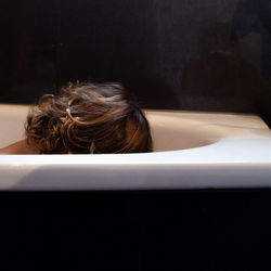 Portrait of woman sitting in bathroom