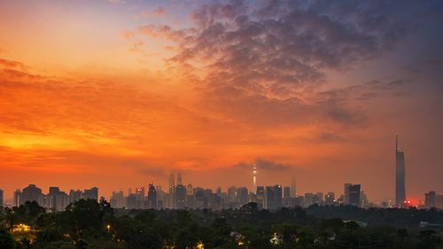 Cityscape against sky during sunset