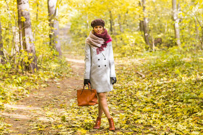 Full length of a woman walking in forest