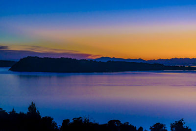 Scenic view of lake against romantic sky at sunset