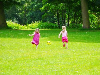 Girl standing on grassy field in park