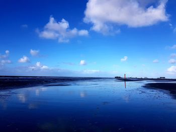 Scenic view of sea against blue sky