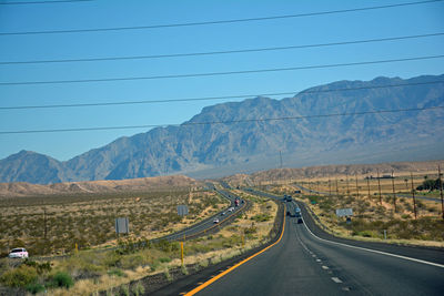 Scenic view of mountains against blue sky