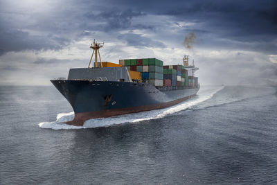 Ship sailing on sea against sky