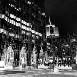 Illuminated city against sky at night