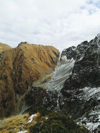 Scenic view of waterfall against sky