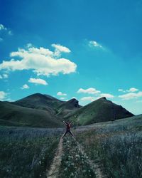 Man on road against mountain range