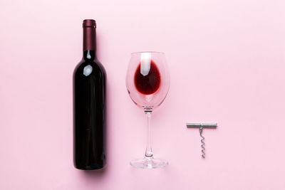 Close-up of wine bottles against pink background