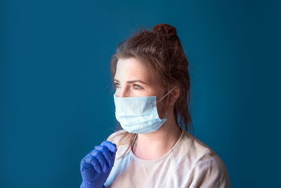 Close-up of woman wearing mask and gloves