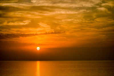 Scenic view of sea against orange sky