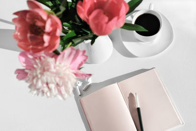 Pink and white flowers in vase on table