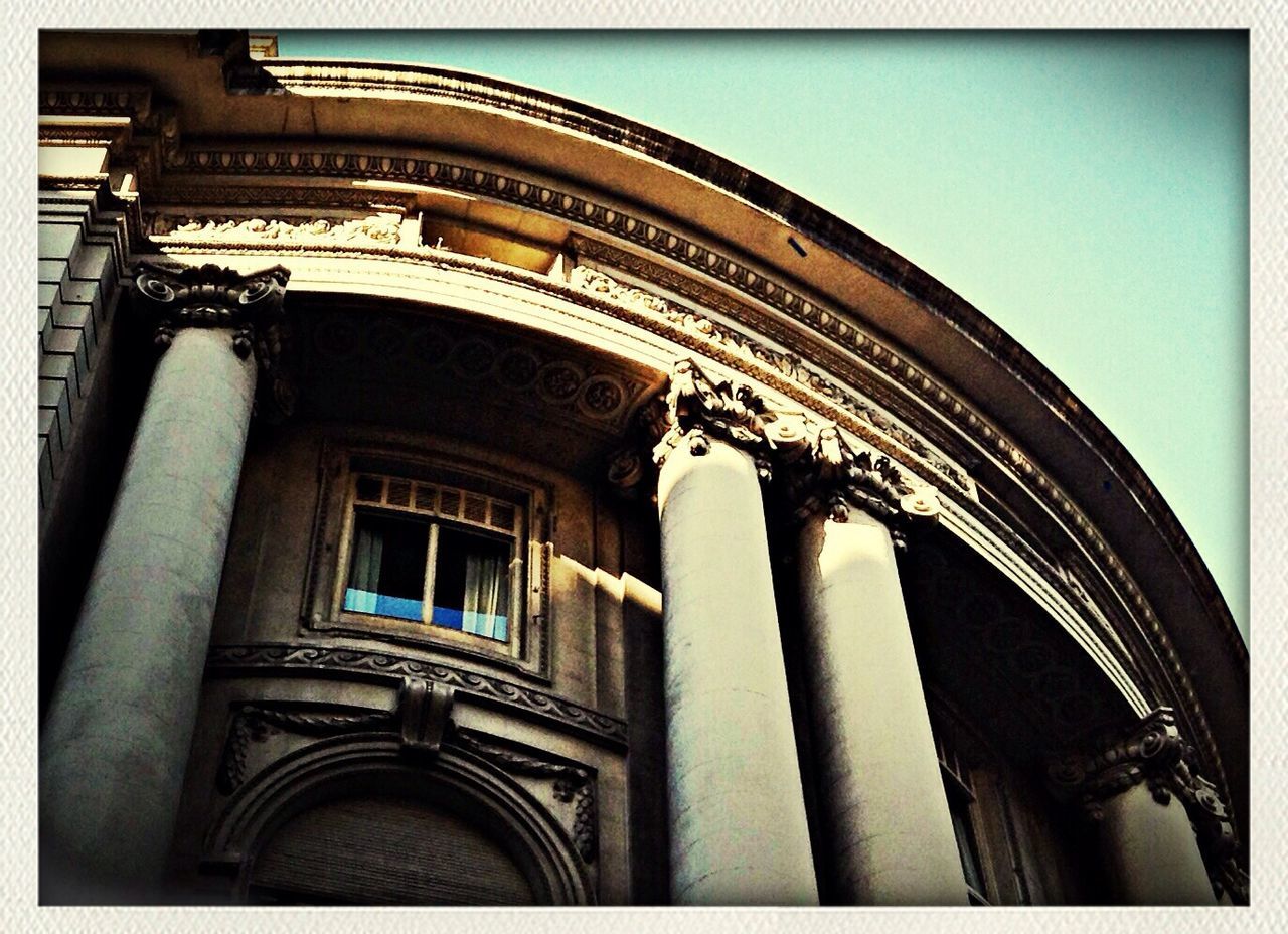 architecture, built structure, building exterior, low angle view, transfer print, arch, auto post production filter, history, architectural column, column, window, facade, famous place, building, travel destinations, clear sky, old, sky, day, historic