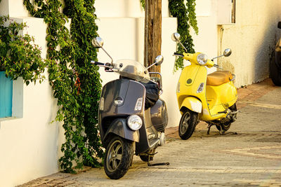 Crete, greece vintage old 2 wheeler scooter of different color parked next to wall. retro scooter