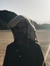 Portrait of man standing against sky