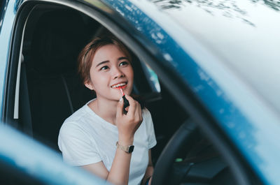 Portrait of smiling woman in car