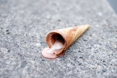 Close-up of fallen ice cream cone on street