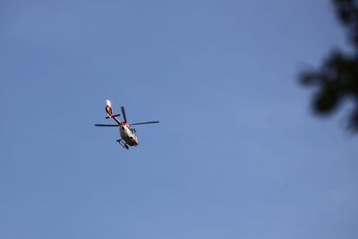 Low angle view of airplane flying against clear sky