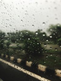 Full frame shot of wet glass window in rainy season