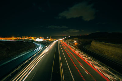 High angle view of light trails on highway at night