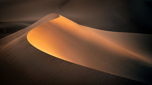 Scenic view of desert against sky during sunset