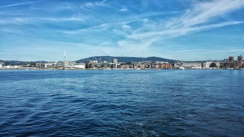 River in city against cloudy sky