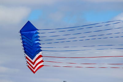 Low angle view of flag against blue sky