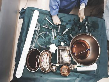 Low section of man working on table