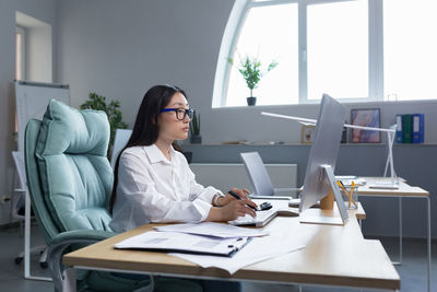 Young businesswoman working at office