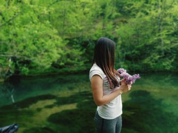 Midsection of woman holding plant