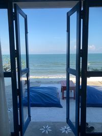 Scenic view of sea against sky seen through window