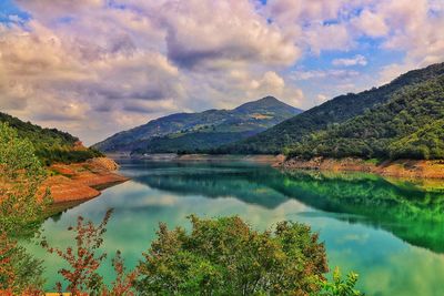 Scenic view of lake and mountains against sky