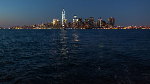 View of city at waterfront at night