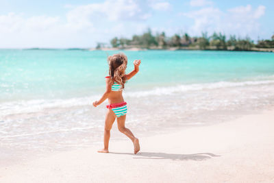 Full length of woman at beach against sky