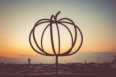 Close-up of silhouette heart shape against sky at sunset