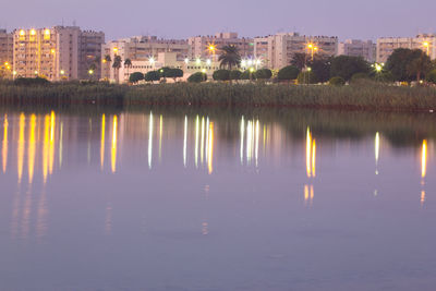 Reflection of illuminated buildings in water at night