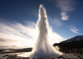 Strokkur geyser erupting against sky